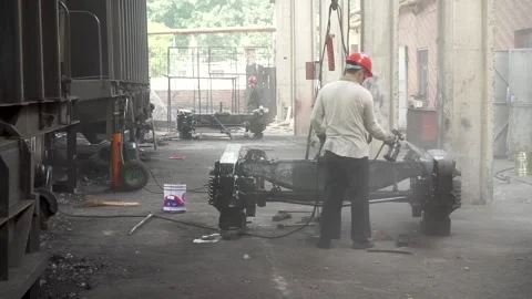 Workers spray paint on the train vehicle chassis Stock Footage 150714980