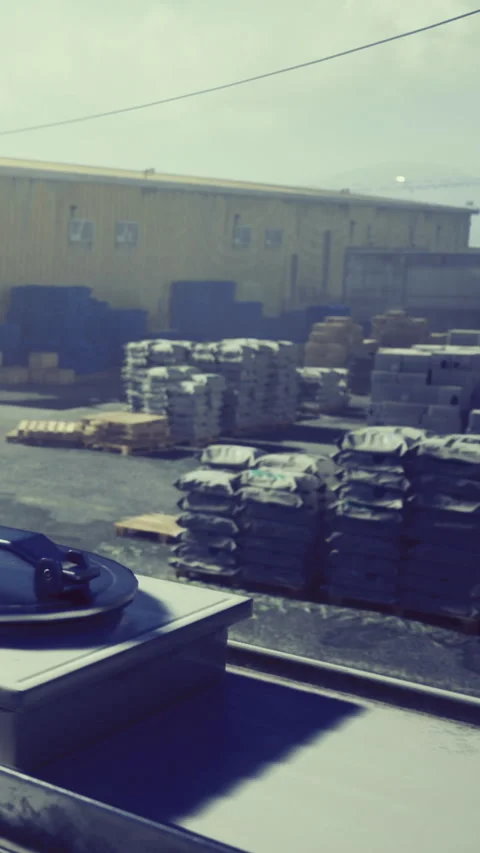 Workers stack bags and crates at a storage facility during daytime hours Stock Footage 332206297