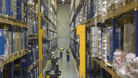 Workers on stackers take cargo from the rack Stock Footage 76020807