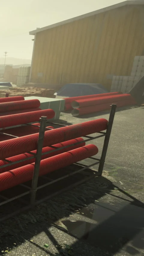 Workers store red pipes at construction site near yellow building in sunlight Vídeos de archivo 337973525
