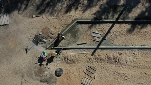 Workers in street work place cut concrete curb, aerial Stock Footage 231601325