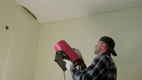 Workers stretch the stretch ceiling , heats the ceiling with a special device Stock Footage 167762696