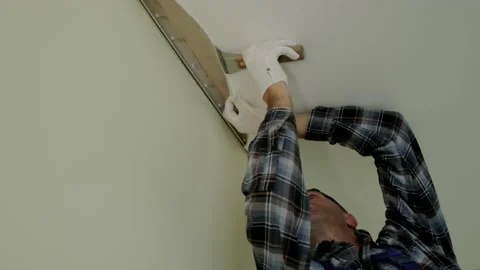 Workers stretch the stretch ceiling in the room. Wide shot Stock Footage 167881849