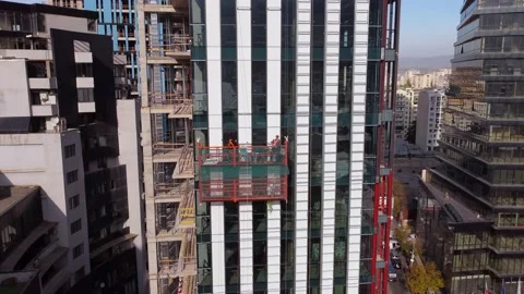 Workers on the suspended cradle Stock Footage 168555615