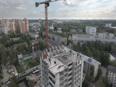 Workers take a concrete slab with a crane on the top floor of the house Stock Footage