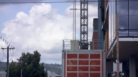 Workers Take Construction Elevator Up A High-Rise Stock Footage 115505414