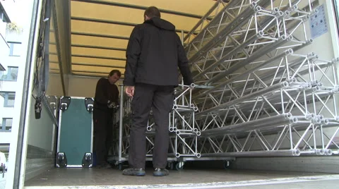 Workers taking cross bars out of a truck Stock Footage 64118164