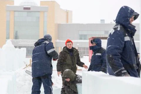 Workers talk on the construction site of the ice town Stock Photos