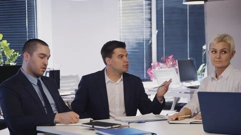 Workers talking about innovation in new startup in office Stock-Footage 115207615