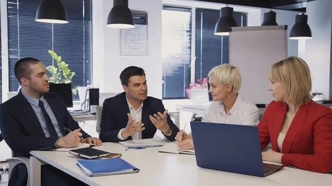 Workers talking about new startup project in office Stock Footage 115207295