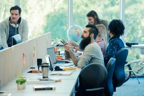 Workers talking in shared office space Stock Photos