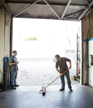 Workers talking at warehouse loading dock Stock Photos