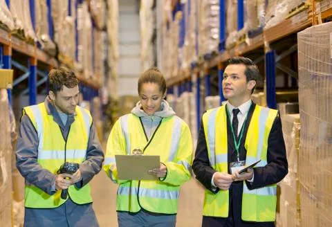 Workers talking in warehouse Stock Photos