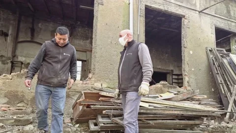 Workers Talking While Wearing a Medical Mask at Ruins Of Abandoned Building Stock Footage 143190424