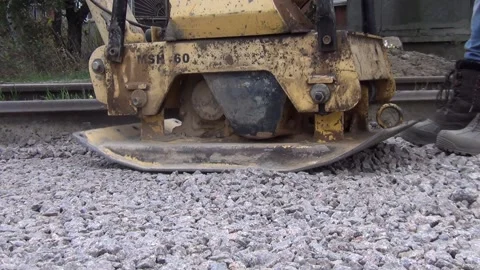 Workers tamp crushed stone using a vibratory plate vibratory rammer 스톡 동영상 148815165