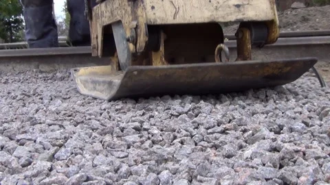 Workers tamp crushed stone using a vibratory plate vibratory rammer 스톡 동영상 148815319