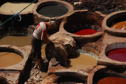 Workers tanning and dyeing in red hides Stock Photos