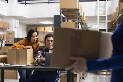 Workers team processing orders and retail shipments in small storehouse Stock Photos