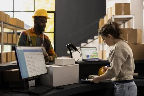 Workers team in a small scale depot facility handling parcel preparation Stock Photos