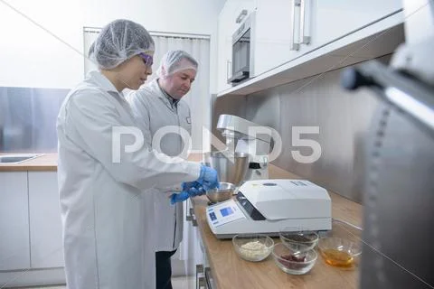 Workers Testing Food In Biscuit Factory