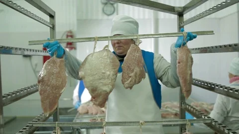 Workers Thread Meat on the Metal Stick Stock Footage 94156984