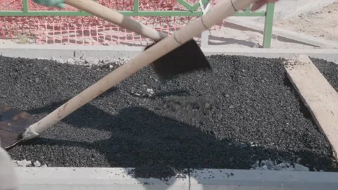 Workers throw asphalt at construction site Stock Footage 132491130