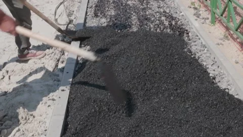 Workers throw asphalt at construction site Stock Footage 132491183