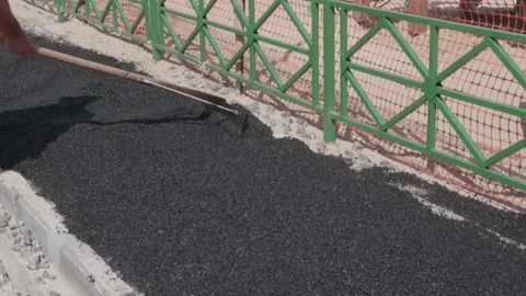 Workers throw asphalt at construction site Stock Footage 132491270