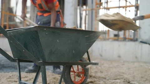 Workers throw sand into the cart Stock Footage 162170037
