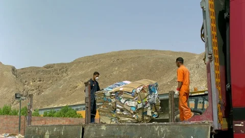 Workers throwing off the bundle of waste from the truck in slow motion Stock Footage 81231526