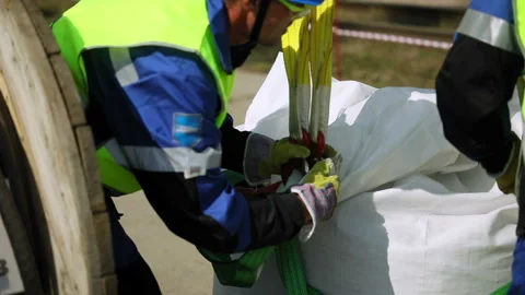 Workers tie ropes to a bag Video stock 93294605
