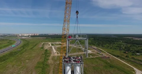 Workers on the top installing chimney pipe segment. Aerial shot Stockbeeldmateriaal 68788497