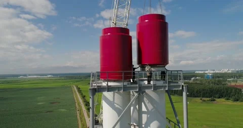 Workers on the top installing chimney pipe segment Stockbeeldmateriaal 141183572