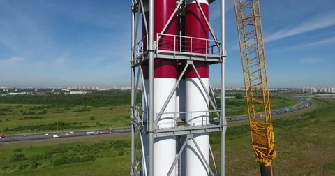 Workers on the top installs a chimney pipe segment for gas power plant Video stock 68788494