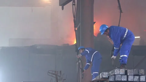 Workers transfer finished steel blocks at the factory Stock Footage 47890452