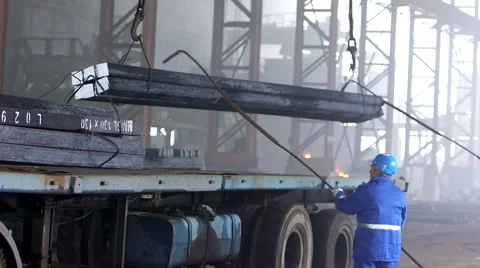 Workers transfer finished steel blocks at the factory Видео 47890466