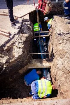 Workers in trench working to assembly new HDPE pipeline Stock Photos