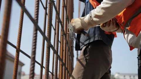 Workers tying rebar at construction site Stock Footage 311881168
