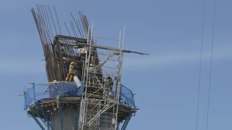 Workers on unfinished suspension bridge construction site Video stock 137873758