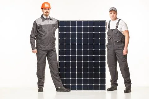 Workers in uniform with solar panels Stock Photos