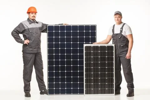 Workers in uniform with solar panels Stock Photos