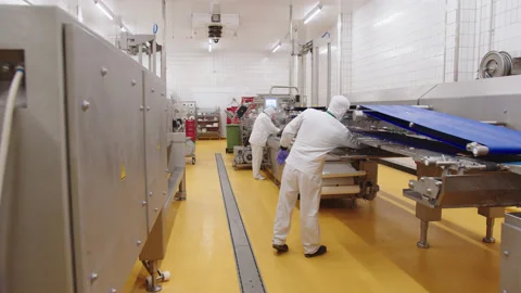 Workers in uniform supervise the operation of automatic line for production of Stock Footage 205489165