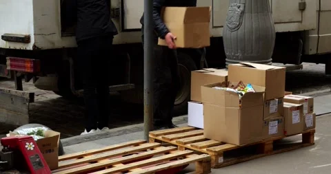 Workers unload boxes from a truck Stock Footage 240097080