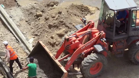 Workers unload concrete with shovels Stock Footage