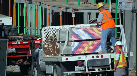 Workers unload drywall from the truck at construction site  in Los Angeles Stock Footage 34503307