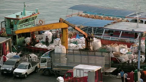 Workers unloading barges of goods in a small city port. Stock Footage 237442239