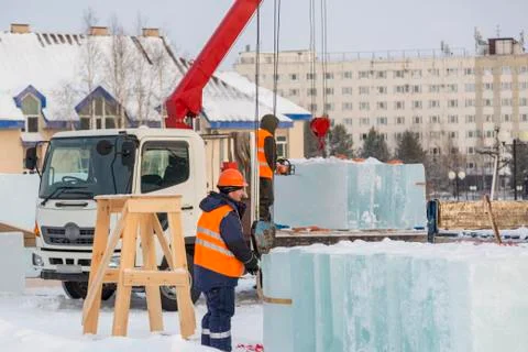 Workers unloading ice blocks from a car 스톡 사진
