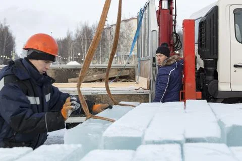 Workers unloading ice blocks from a car 스톡 사진