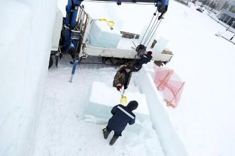 Workers unloading ice blocks from a car 스톡 사진