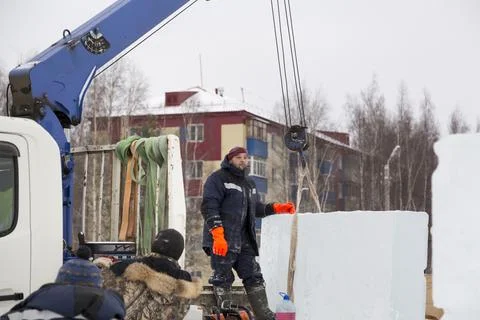 Workers unloading ice blocks from a car 스톡 사진